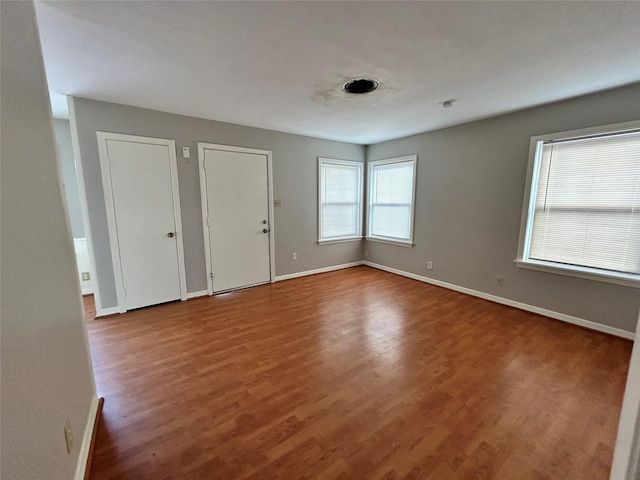 interior space with two closets and wood-type flooring