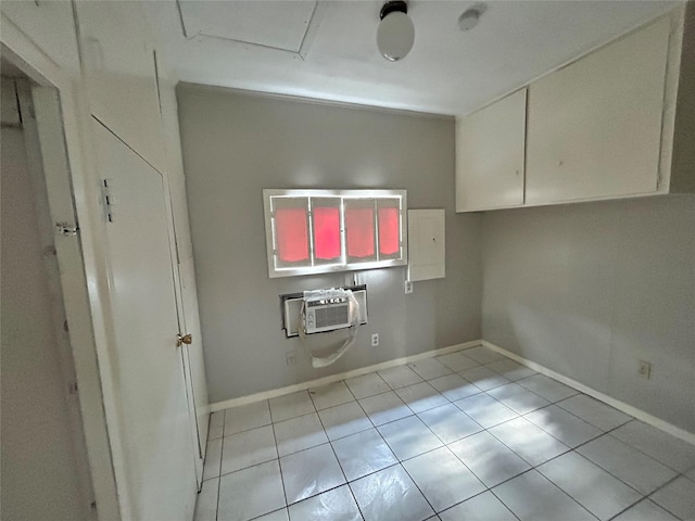 laundry area featuring a wall mounted AC and light tile patterned flooring