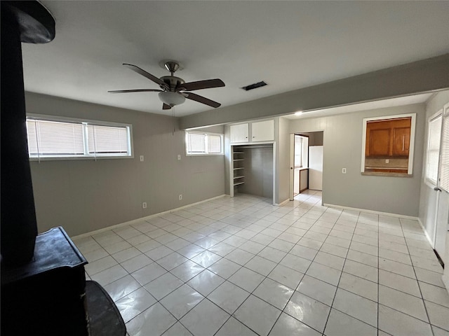 unfurnished bedroom featuring light tile patterned floors and ceiling fan