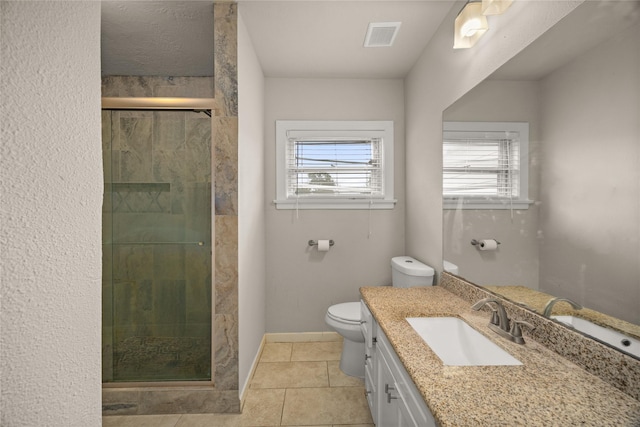 bathroom with an enclosed shower, vanity, tile patterned flooring, and toilet