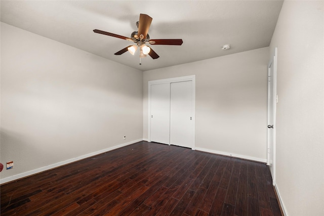 unfurnished bedroom with ceiling fan, dark hardwood / wood-style flooring, and a closet