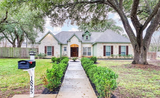 french country home with a front lawn