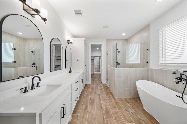 bathroom with vanity and separate shower and tub