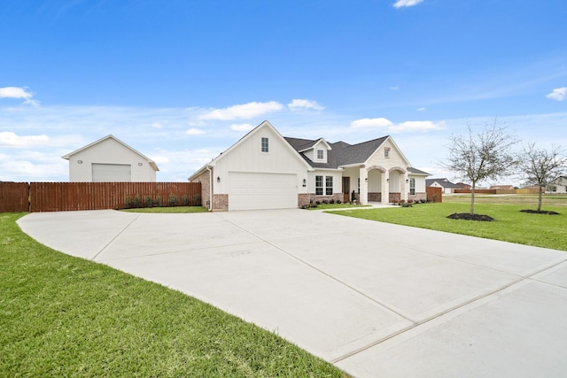 view of front of house with a garage and a front lawn