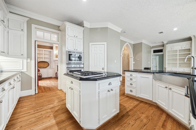 kitchen featuring white cabinetry, sink, light hardwood / wood-style flooring, and appliances with stainless steel finishes