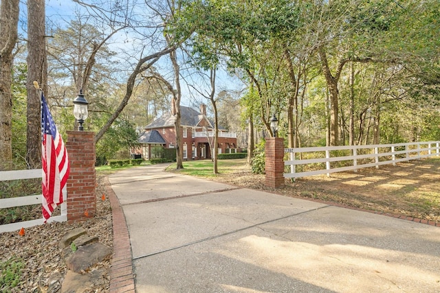 view of road with street lighting and concrete driveway