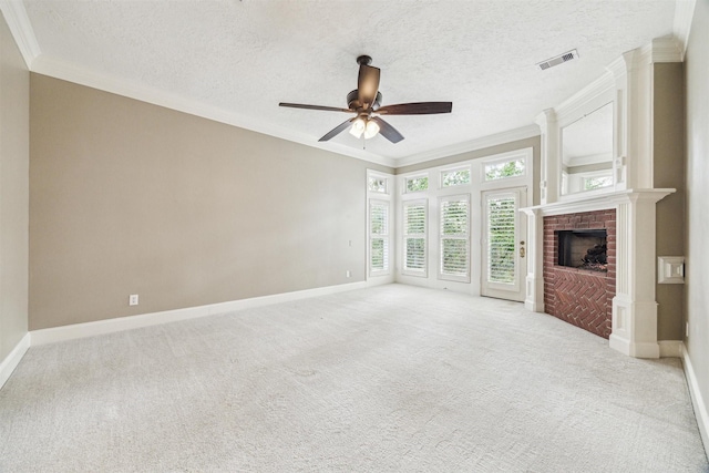 unfurnished living room with crown molding, a brick fireplace, light carpet, and a textured ceiling