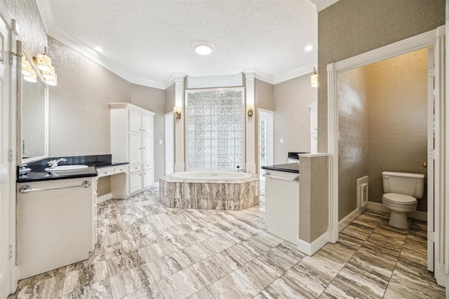 bathroom featuring crown molding, a relaxing tiled tub, vanity, a textured ceiling, and toilet