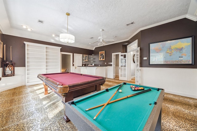 rec room with ceiling fan, carpet floors, ornamental molding, a textured ceiling, and pool table