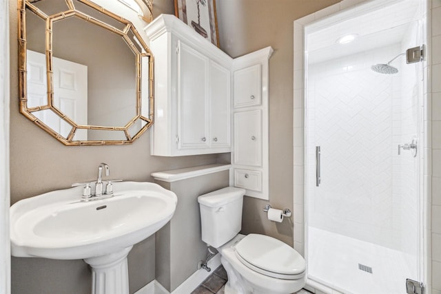 bathroom with sink, toilet, and walk in shower