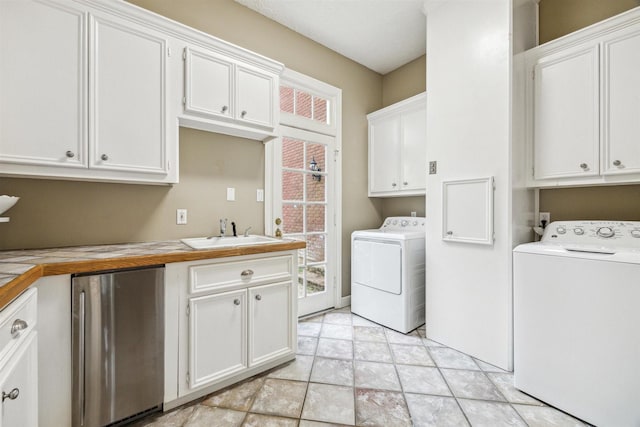 clothes washing area with washer / clothes dryer, light tile patterned flooring, sink, and cabinets