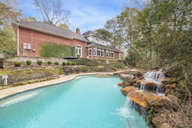 view of swimming pool featuring pool water feature