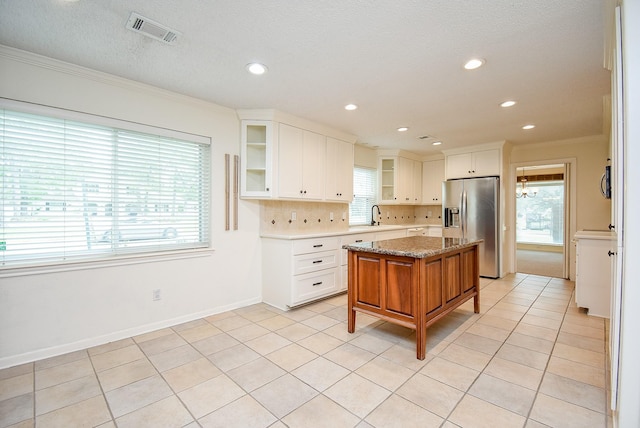 19431 Joanleigh Dr, Spring, TX 77388 - kitchen with a sink, stainless steel fridge with ice dispenser, visible vents, ornamental molding, and glass insert cabinets
