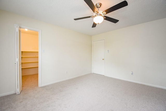 19431 Joanleigh Dr, Spring, TX 77388 - unfurnished bedroom featuring a walk in closet, a ceiling fan, baseboards, a closet, and carpet