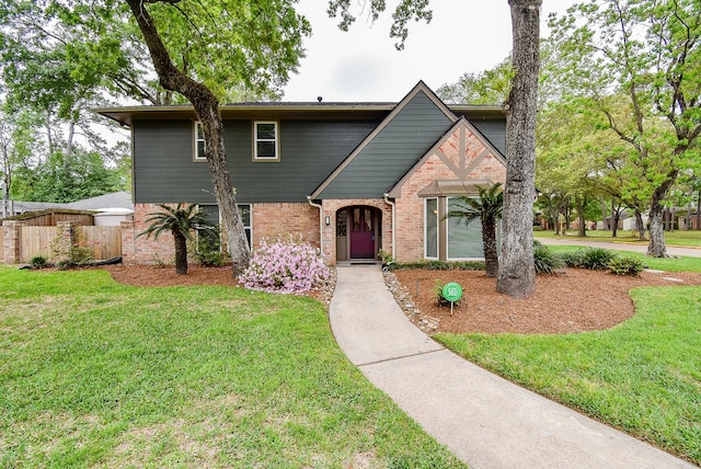 19431 Joanleigh Dr, Spring, TX 77388 - view of front of house featuring brick siding, a front lawn, and fence