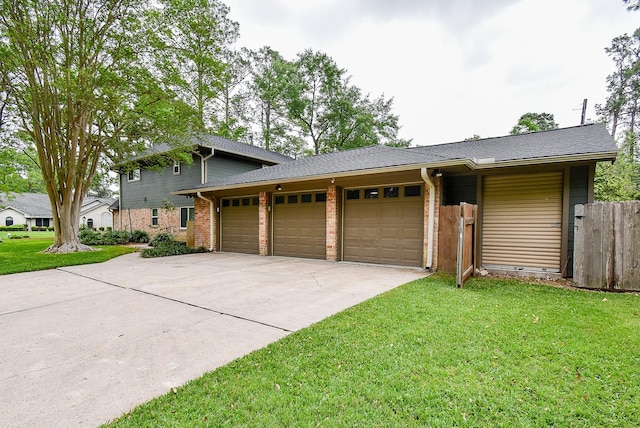 19431 Joanleigh Dr, Spring, TX 77388 - view of front of home with a front yard, brick siding, fence, concrete driveway, and an attached garage