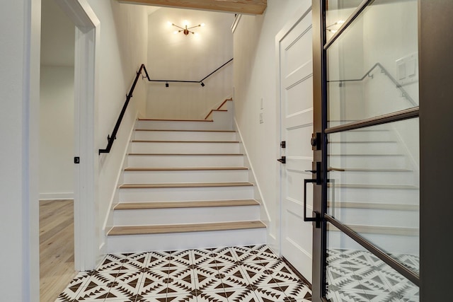 stairs featuring hardwood / wood-style floors