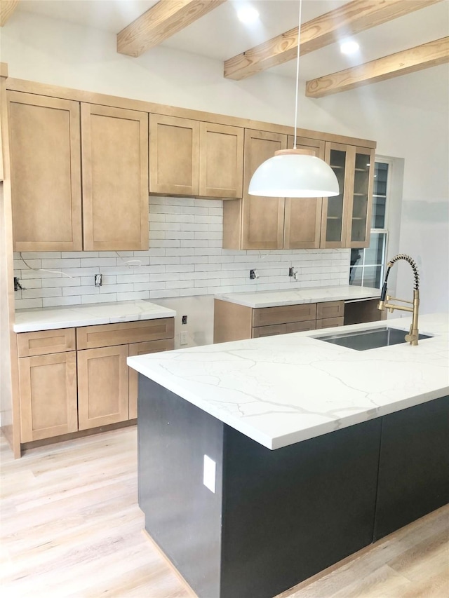 2215 Bevis St, Houston, TX 77008 - kitchen with light wood-style floors, beamed ceiling, light stone countertops, tasteful backsplash, and pendant lighting
