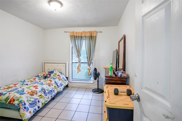 tiled bedroom with a textured ceiling