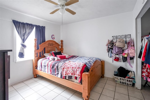 bedroom featuring light tile patterned flooring and ceiling fan