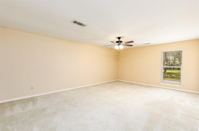 unfurnished room with light carpet, ceiling fan, visible vents, and baseboards