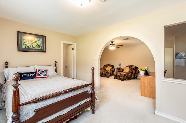 bedroom with baseboards, arched walkways, and carpet flooring