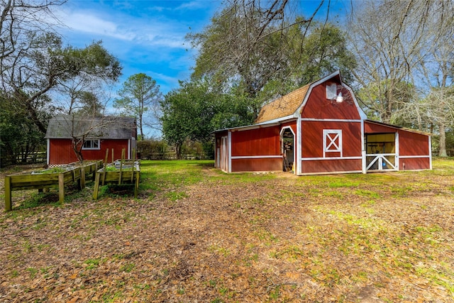 view of yard with a barn and an outbuilding