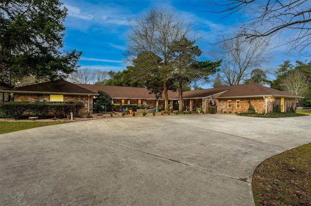 ranch-style house with concrete driveway