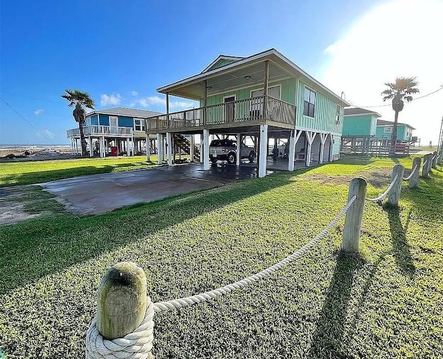 exterior space featuring a carport, a lawn, and driveway