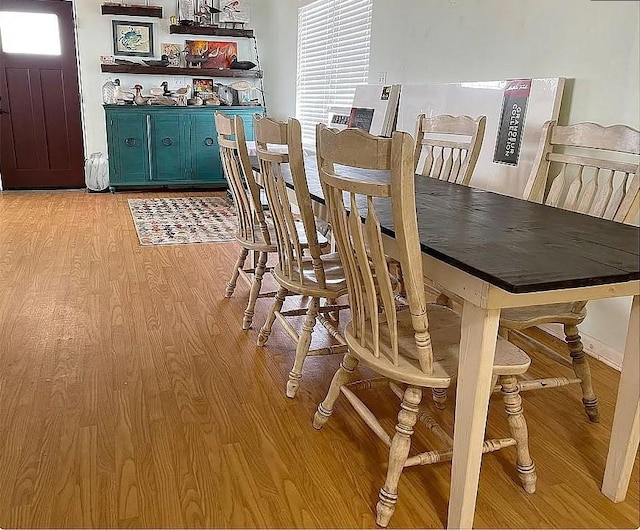 dining space featuring plenty of natural light and light hardwood / wood-style flooring