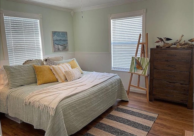 bedroom with crown molding and dark hardwood / wood-style floors