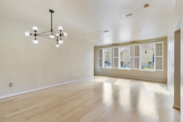 505 Jackson Hill St S Unit 108, Houston, TX 77007 - unfurnished room featuring a chandelier, baseboards, light wood-style flooring, and a smoke detector