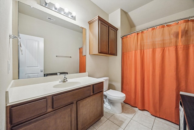 bathroom with toilet, vanity, visible vents, and tile patterned floors