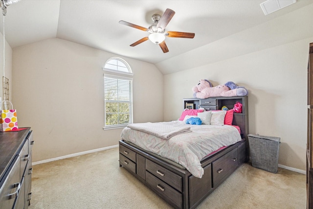 bedroom with light colored carpet, visible vents, a ceiling fan, vaulted ceiling, and baseboards