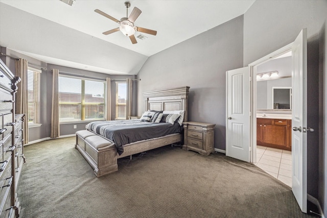 bedroom with light carpet, vaulted ceiling, visible vents, and ensuite bathroom