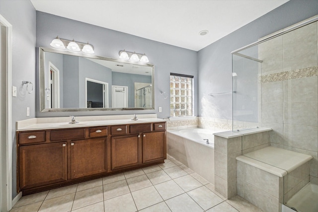 full bath featuring double vanity, a garden tub, a shower stall, and a sink