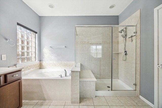 bathroom featuring a stall shower, tile patterned flooring, a bath, and vanity