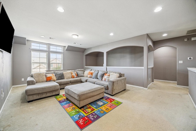 living room with light carpet, baseboards, arched walkways, and recessed lighting