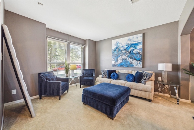 living room featuring light carpet and baseboards