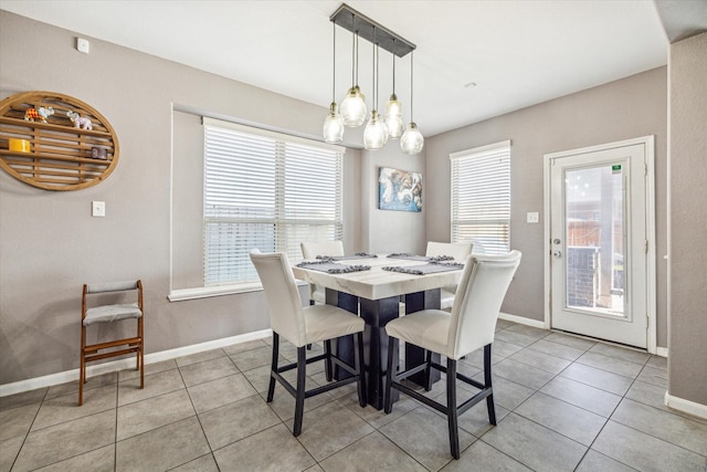 dining room featuring light tile patterned floors and baseboards