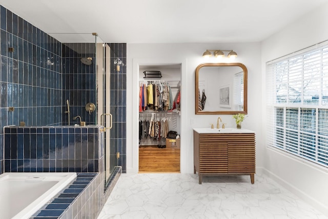 bathroom featuring vanity and independent shower and bath