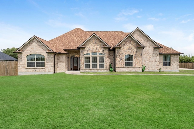 french provincial home featuring a front lawn