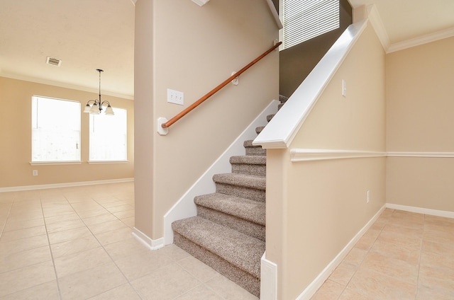 stairs featuring ornamental molding, tile patterned floors, and a chandelier