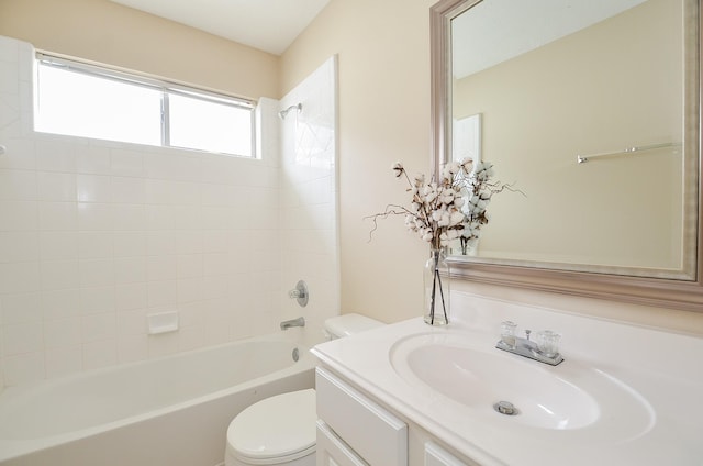 full bathroom featuring vanity, tiled shower / bath combo, and toilet