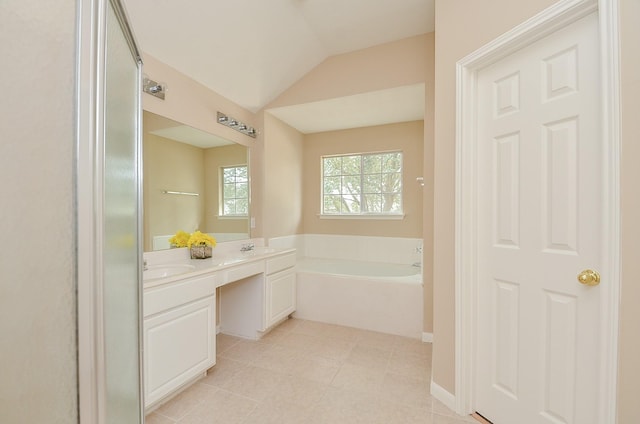 bathroom featuring vanity, lofted ceiling, a bath, and tile patterned floors