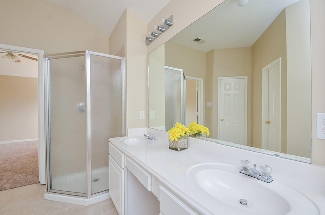 bathroom with tile patterned floors, a shower with door, and vanity