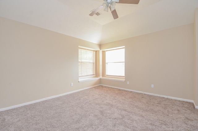 empty room with vaulted ceiling, light colored carpet, and ceiling fan