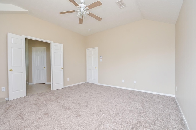 carpeted spare room with lofted ceiling and ceiling fan