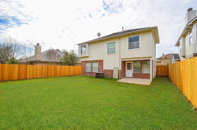 rear view of house with a patio area and a lawn