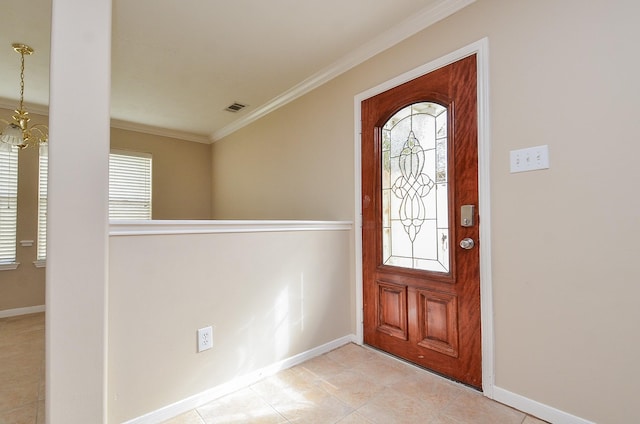 entrance foyer with a notable chandelier, crown molding, and plenty of natural light